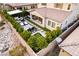 Aerial view of backyard featuring outdoor kitchen, dining area, putting green, and lounge area at 3929 Reyes Ave, Las Vegas, NV 89141