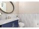 Chic powder room with a navy blue vanity and textured white wall tiles at 3929 Reyes Ave, Las Vegas, NV 89141