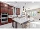 Open-concept kitchen features a large island, stainless steel appliances, and breakfast bar at 3929 Reyes Ave, Las Vegas, NV 89141