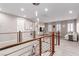 Second floor landing featuring modern railings, light fixtures and an adjacent living area at 3929 Reyes Ave, Las Vegas, NV 89141