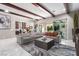 Open-plan living room boasts a sectional, stylish furnishings, and large glass doors to the patio at 3929 Reyes Ave, Las Vegas, NV 89141