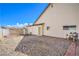 Spacious backyard with rock landscaping, side gate and partial brick border around the perimeter at 3963 Redwood St, Las Vegas, NV 89103