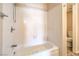 Bathroom featuring a shower-tub combo with white tiled walls and modern fixtures at 3963 Redwood St, Las Vegas, NV 89103