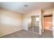 Bedroom with mirrored closet doors and view of the staircase and living area at 3963 Redwood St, Las Vegas, NV 89103