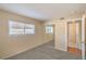 Comfortable bedroom featuring plush carpet, large window, mirrored closet doors, and adjacent bathroom access at 3963 Redwood St, Las Vegas, NV 89103