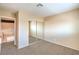 Bedroom with mirrored closet doors and view of the staircase and living area at 3963 Redwood St, Las Vegas, NV 89103