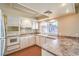 Bright kitchen featuring white cabinets, tile backsplash, and ample counter space at 3963 Redwood St, Las Vegas, NV 89103