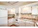 Efficient kitchen with modern appliances, mosaic backsplash, tiled countertops, and ample cabinet space at 3963 Redwood St, Las Vegas, NV 89103