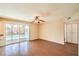 Spacious living area featuring wood floors, sliding glass doors with access to the backyard pool, and a ceiling fan at 3963 Redwood St, Las Vegas, NV 89103