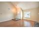 Inviting living room with vaulted ceilings, wood floors, chandelier, and a large window providing ample natural light at 3963 Redwood St, Las Vegas, NV 89103