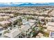 Beautiful aerial view showcases a neighborhood with mountain views, pools, and well-maintained landscaping at 4208 Lower Saxon Ave, North Las Vegas, NV 89085