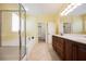 Well-lit bathroom with double vanity, separate shower, and a soaking tub at 4208 Lower Saxon Ave, North Las Vegas, NV 89085