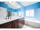 Bathroom with double sinks, soaking tub, and glass-enclosed shower at 4208 Lower Saxon Ave, North Las Vegas, NV 89085