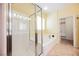 Bright bathroom featuring a glass shower, a tub, and tile flooring at 4208 Lower Saxon Ave, North Las Vegas, NV 89085