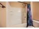 This bathroom features a shower over tub with tile surround and a curtain at 4208 Lower Saxon Ave, North Las Vegas, NV 89085