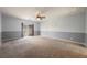 Spacious carpeted bedroom with ceiling fan and sliding glass doors to a balcony at 4208 Lower Saxon Ave, North Las Vegas, NV 89085