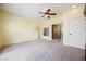 Bedroom with neutral carpeting, a ceiling fan, and an decorative wall art at 4208 Lower Saxon Ave, North Las Vegas, NV 89085
