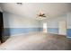 Large carpeted bedroom featuring modern ceiling fan and adjacent doorway at 4208 Lower Saxon Ave, North Las Vegas, NV 89085