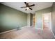 Carpeted bedroom featuring a ceiling fan and entrances to a closet and hallway at 4208 Lower Saxon Ave, North Las Vegas, NV 89085