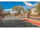 Beautiful gated community entrance with stone columns, lush trees, and well-maintained landscaping at 4208 Lower Saxon Ave, North Las Vegas, NV 89085
