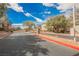 Elegant community entrance featuring stone pillars, manicured landscaping, and a secure gate at 4208 Lower Saxon Ave, North Las Vegas, NV 89085