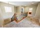 Carpeted landing with wood and iron railing leads to multiple rooms at 4208 Lower Saxon Ave, North Las Vegas, NV 89085