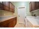 Functional laundry room with tile floors, wood cabinets, and washer and dryer at 4208 Lower Saxon Ave, North Las Vegas, NV 89085