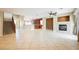 Large living space with tile floors, fireplace, and stairs to upper level at 4208 Lower Saxon Ave, North Las Vegas, NV 89085