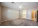 Bright main bedroom with carpet flooring, ceiling fan, and en-suite bathroom access at 4208 Lower Saxon Ave, North Las Vegas, NV 89085