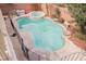 Private backyard swimming pool with a raised jacuzzi and stone landscaping at 4208 Lower Saxon Ave, North Las Vegas, NV 89085