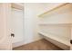 Walk-in closet with white shelving, hanging rod, and neutral carpeting at 4208 Lower Saxon Ave, North Las Vegas, NV 89085