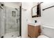 Modern bathroom featuring a glass-enclosed shower, a wooden vanity, and contemporary fixtures at 4360 Wendy Ln, Las Vegas, NV 89115