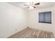 Bright bedroom featuring neutral carpet, a ceiling fan, and a window with blinds for natural light at 4360 Wendy Ln, Las Vegas, NV 89115