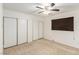 Spacious bedroom features a ceiling fan and a closet with sliding doors, perfect for storage at 4360 Wendy Ln, Las Vegas, NV 89115