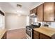 Bright kitchen showcases wood-look floors, gas range, and light countertops, ideal for cooking and dining at 4360 Wendy Ln, Las Vegas, NV 89115