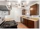 A cozy kitchen featuring wooden cabinets, laminate countertops, and a stainless steel gas range at 4360 Wendy Ln, Las Vegas, NV 89115