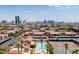 Aerial view of the community showcasing a swimming pool, tennis courts, and nearby city skyline at 4411 Alexis Dr # 444, Las Vegas, NV 89103