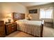 Bedroom with nightstands, lamps, and bed with patterned bedding at 4411 Alexis Dr # 444, Las Vegas, NV 89103