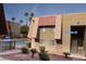 A low-angle exterior view of a tan apartment complex near a community pool at 4411 Alexis Dr # 444, Las Vegas, NV 89103