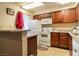 Kitchen featuring wooden cabinets, white appliances, and tiled floor at 4411 Alexis Dr # 444, Las Vegas, NV 89103