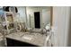 Modern bathroom vanity featuring a granite countertop, decorative accents, and a large mirror at 4533 Morton Grove Ave, Las Vegas, NV 89115