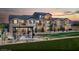 Charming townhome showcasing a picnic area, a well-maintained lawn, and exterior architectural details at 470 Ylang Pl # Lot 9, Henderson, NV 89015
