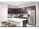 Modern kitchen with stainless steel appliances, a large island, and dark wood cabinets at 470 Ylang Pl # Lot 9, Henderson, NV 89015