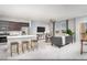 Open concept living room with kitchen, stainless steel appliances, marble floors, and mountain view at 470 Ylang Pl # Lot 9, Henderson, NV 89015