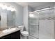 Bathroom featuring granite countertop sink and tiled shower with sliding doors at 5166 Silverheart Ave, Las Vegas, NV 89142