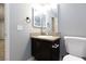 Cozy bathroom featuring granite countertops and a framed mirror, illuminated by modern lighting at 5166 Silverheart Ave, Las Vegas, NV 89142
