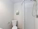 Bathroom featuring a toilet and shower with white tile at 5166 Silverheart Ave, Las Vegas, NV 89142