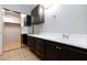Spacious bathroom showing double sinks, storage and tile floors plus a closet mirrored door at 5166 Silverheart Ave, Las Vegas, NV 89142