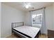 Bedroom with a bed, ceiling fan, tile floor, and a window providing natural light at 5166 Silverheart Ave, Las Vegas, NV 89142