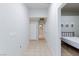 Hallway leading to other rooms, featuring tiled floors and neutral-colored walls at 5166 Silverheart Ave, Las Vegas, NV 89142